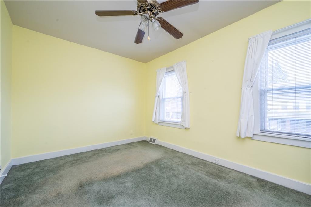 1819 Viruth Street Pittsburgh, PA 15212 - Photo 33 of 50 an empty room with a window and a chandelier fan