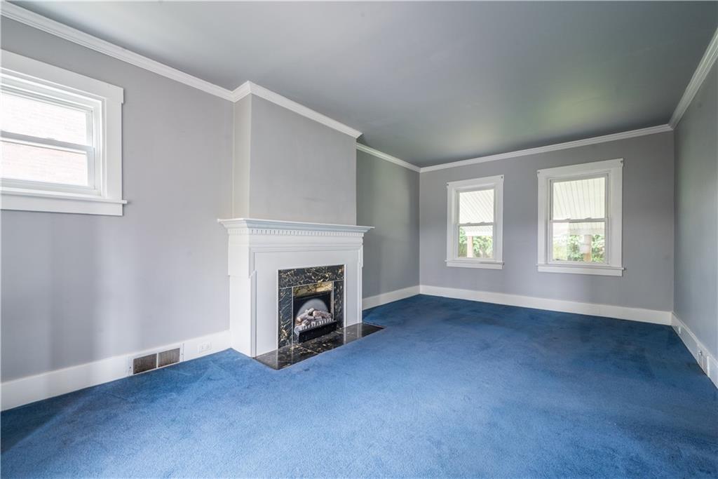 1819 Viruth Street Pittsburgh, PA 15212 - Photo 4 of 50 an empty room with windows and fireplace