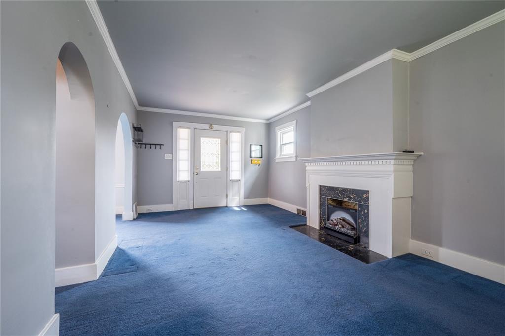 1819 Viruth Street Pittsburgh, PA 15212 - Photo 6 of 50 an empty room with windows fireplace and hardwood floor