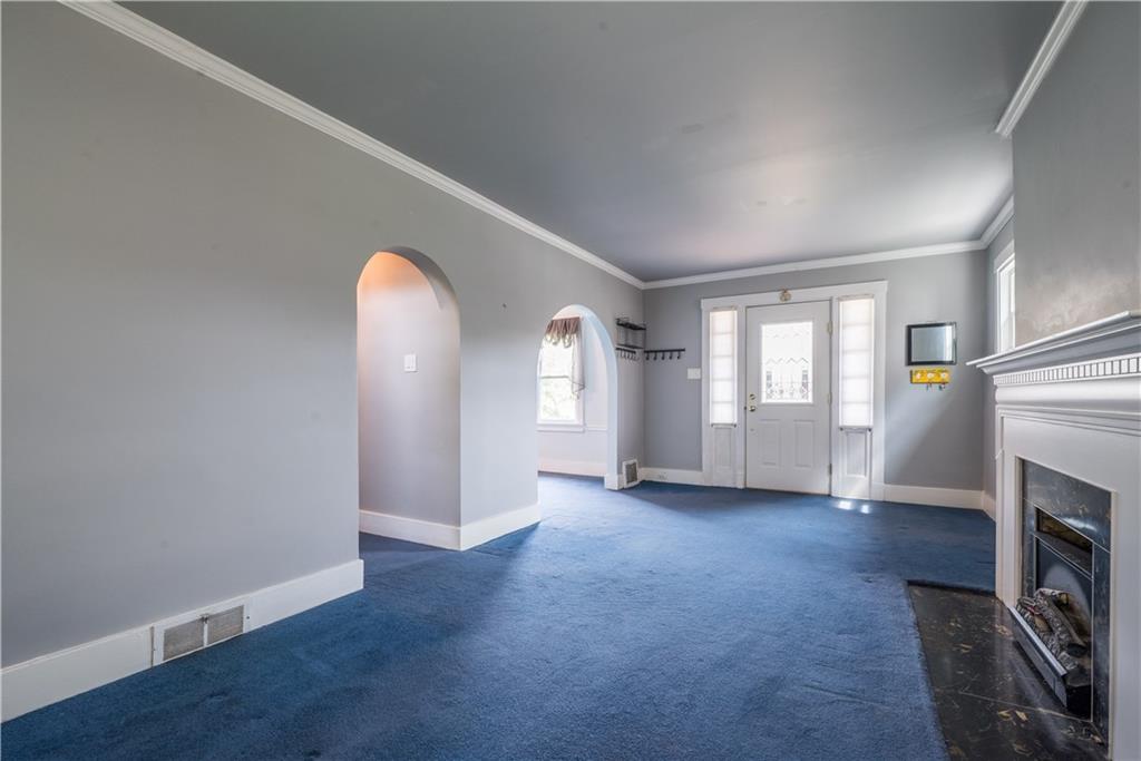 1819 Viruth Street Pittsburgh, PA 15212 - Photo 7 of 50 an empty room with windows fireplace and wooden floor
