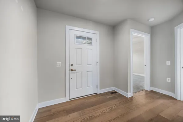 an empty room with wooden floor