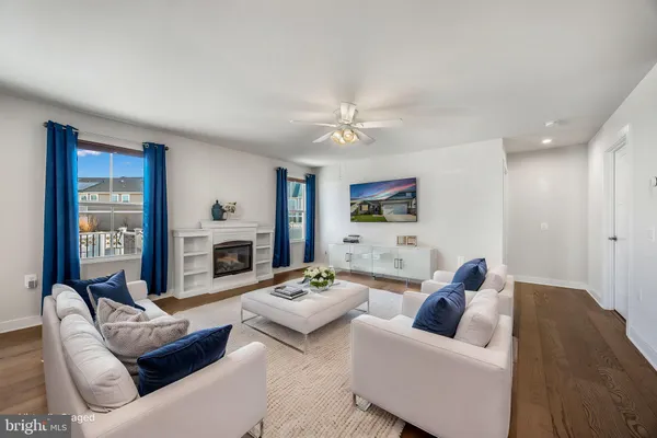 a living room with furniture fireplace and a large window