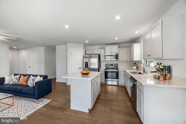 a kitchen with counter top space a sink and appliances