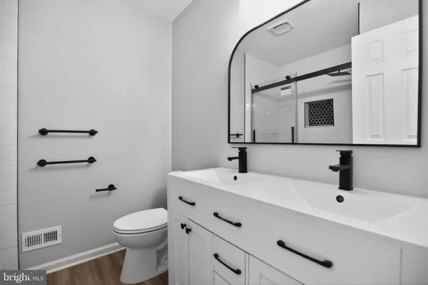a bathroom with a toilet a sink and mirror