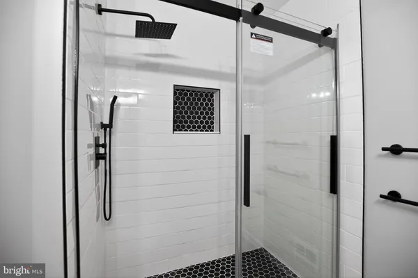 a bathroom with a shower and a glass door
