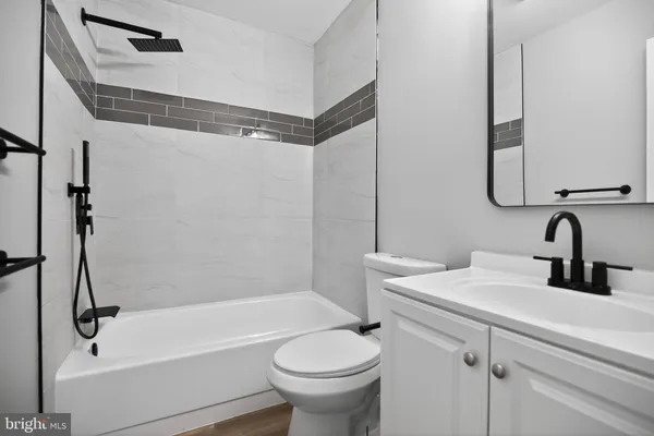 a bathroom with a sink a toilet and a bathtub