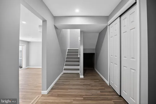 a view of a hallway with wooden floor and entryway