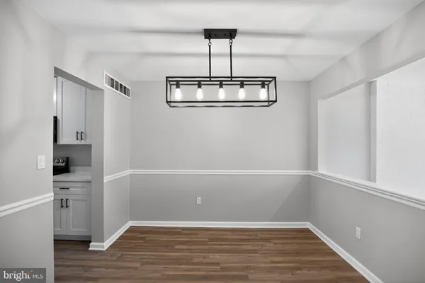 a view of room with window and wooden floor