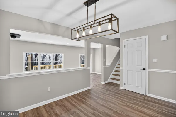 a view of an entryway with wooden floor and stairs