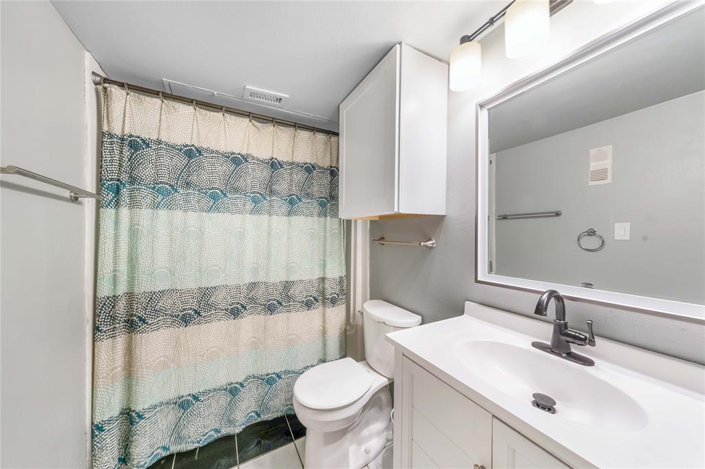 13217 Emily Road, Unit 3209 Dallas, TX 75240 - Photo 13 of 26 a bathroom with a sink toilet and shower