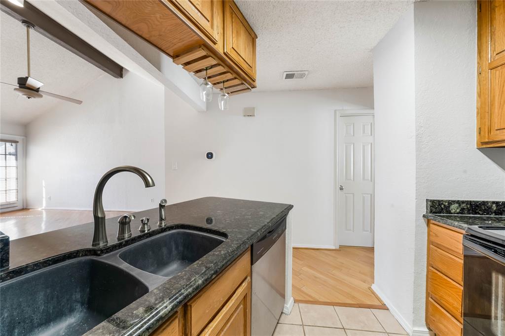 13217 Emily Road, Unit 3209 Dallas, TX 75240 - Photo 8 of 26 a kitchen with a sink and a stove top oven