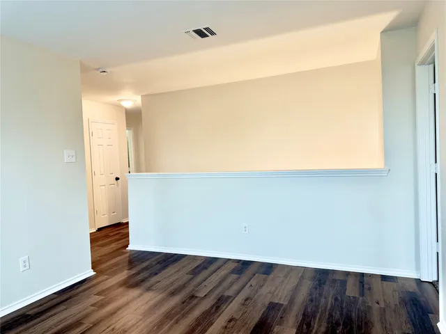a view of a kitchen with wooden floor and electronic appliances