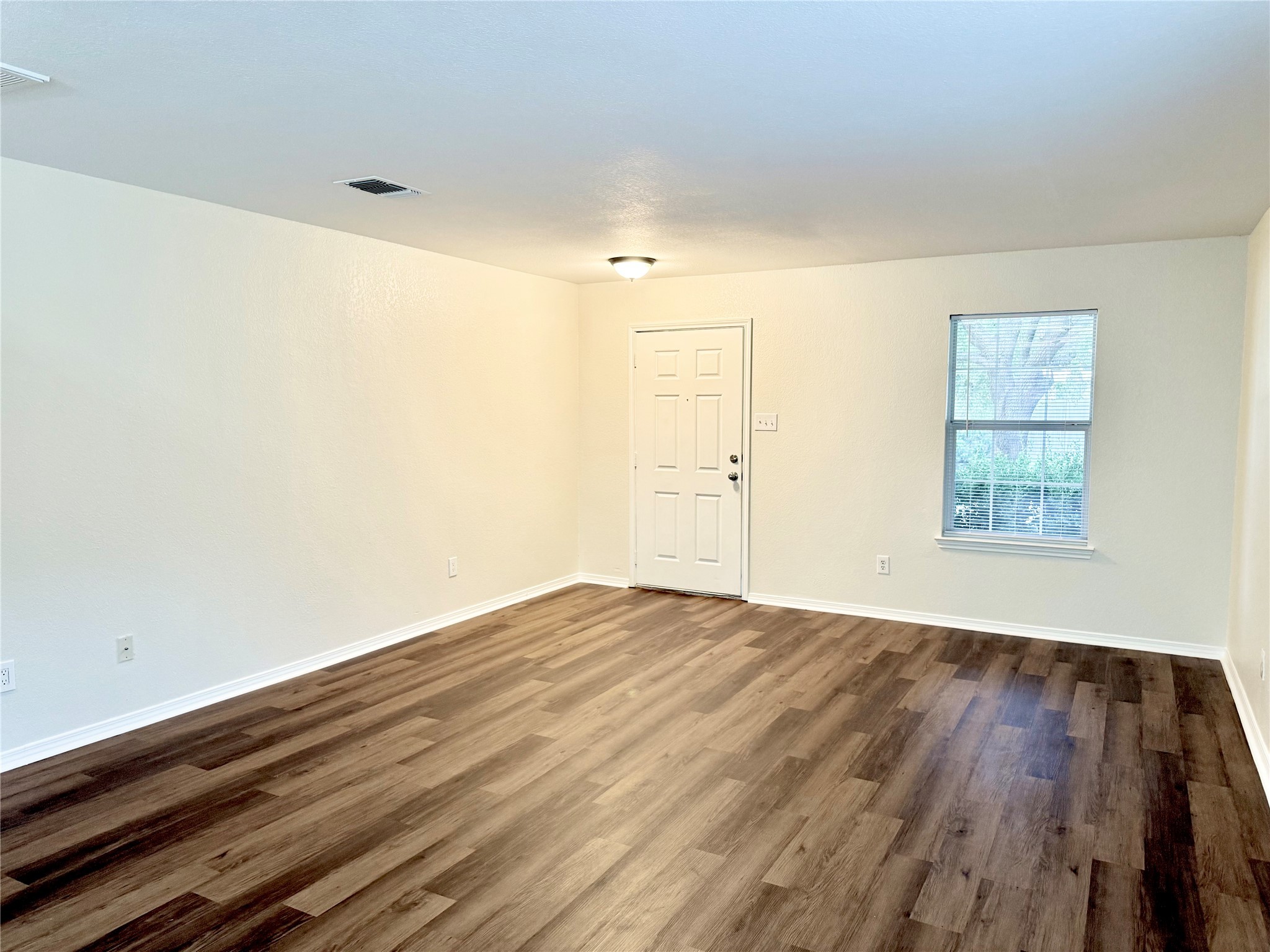 3814 Silver Bridge Lane Katy, TX 77449 - Photo 3 of 20 an empty room with wooden floor and windows