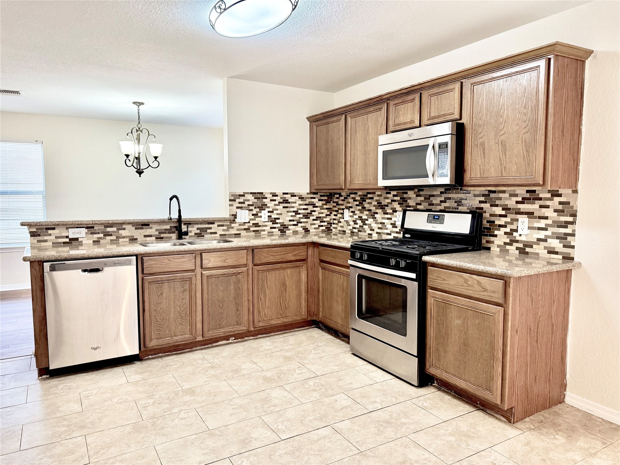3814 Silver Bridge Lane Katy, TX 77449 - Photo 6 of 20 a kitchen with a stove sink and cabinets