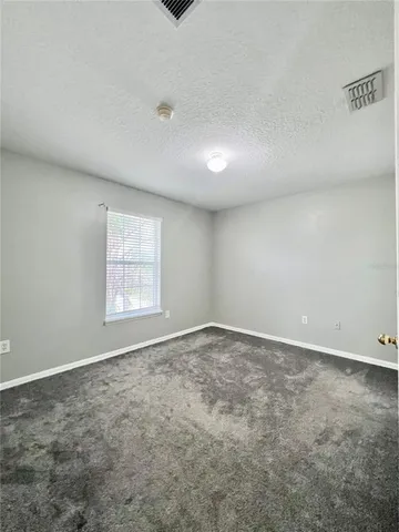 an empty room with a empty space and a window