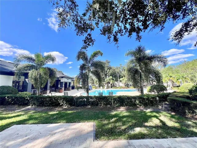 a front view of a house with a yard and green space