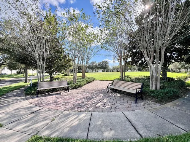 a park view with a bench in a garden