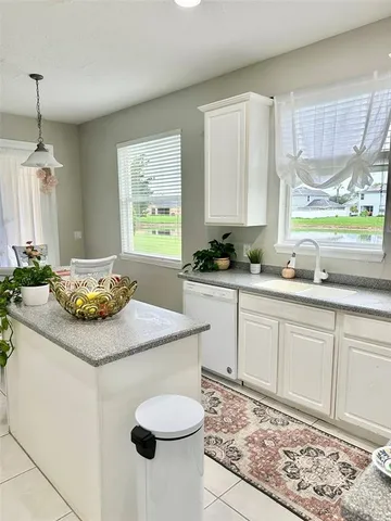 a kitchen with sink cabinets and window