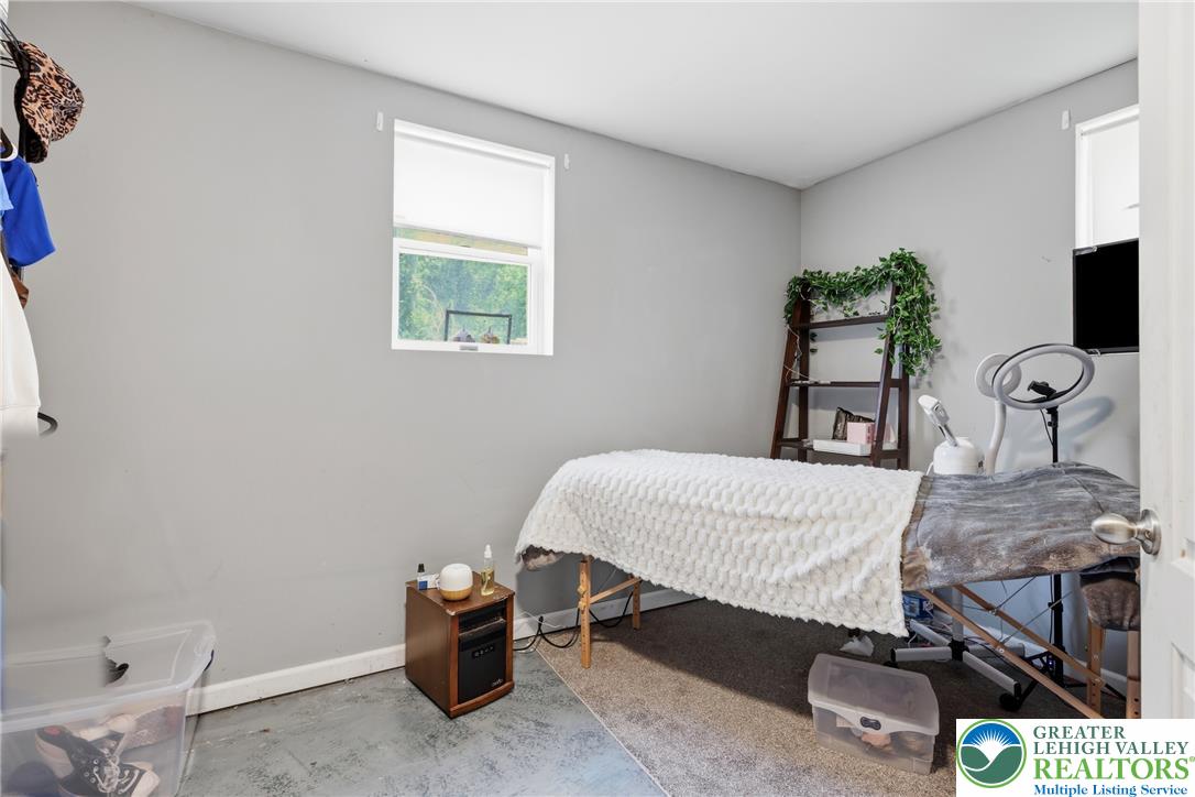 732 Bushkill Center Road Nazareth, PA 18064 - Photo 27 of 43 A versatile room with ample light, offering a window view and durable concrete flooring.