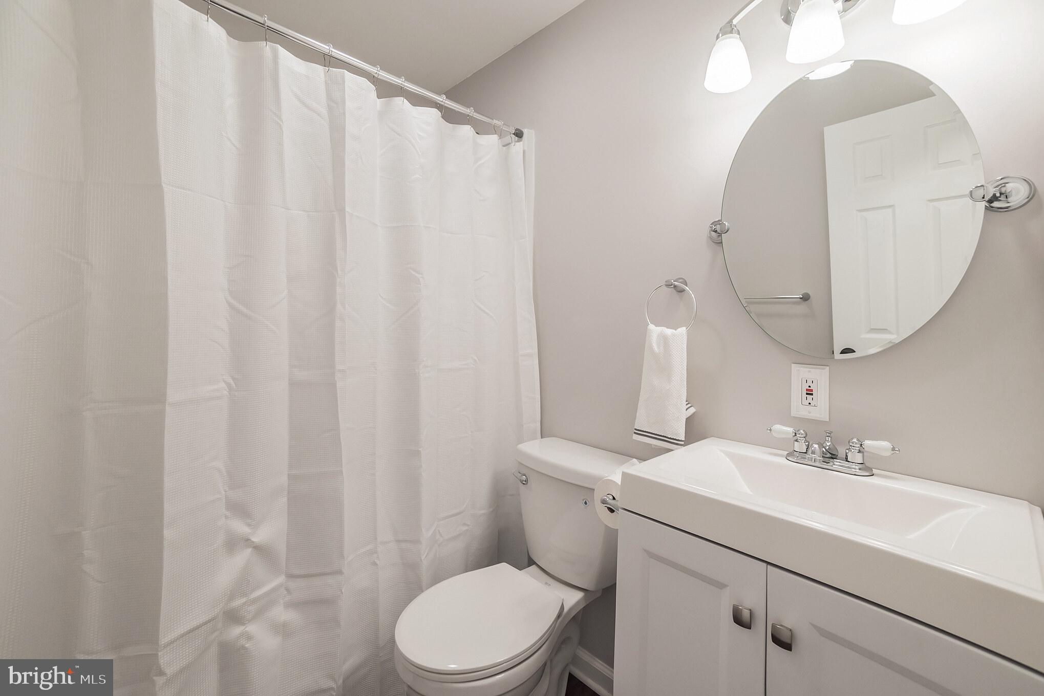 312 Fenwick Road Pilesgrove, NJ 08098 - Photo 20 of 40 a bathroom with a sink a mirror and a toilet