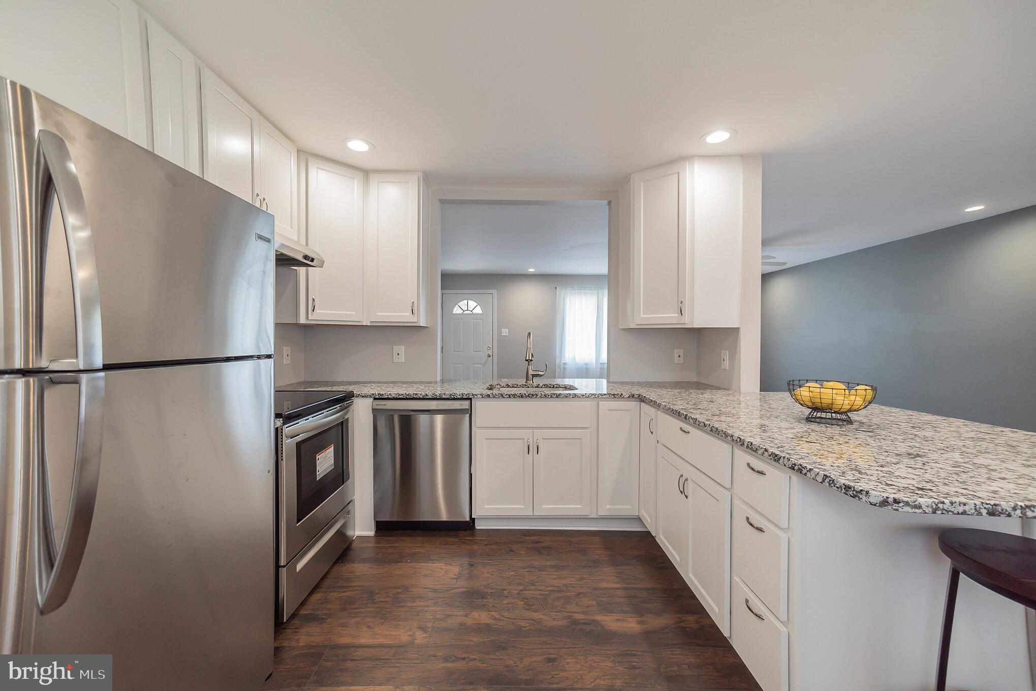 312 Fenwick Road Pilesgrove, NJ 08098 - Photo 3 of 40 a kitchen with granite countertop a sink stove and refrigerator