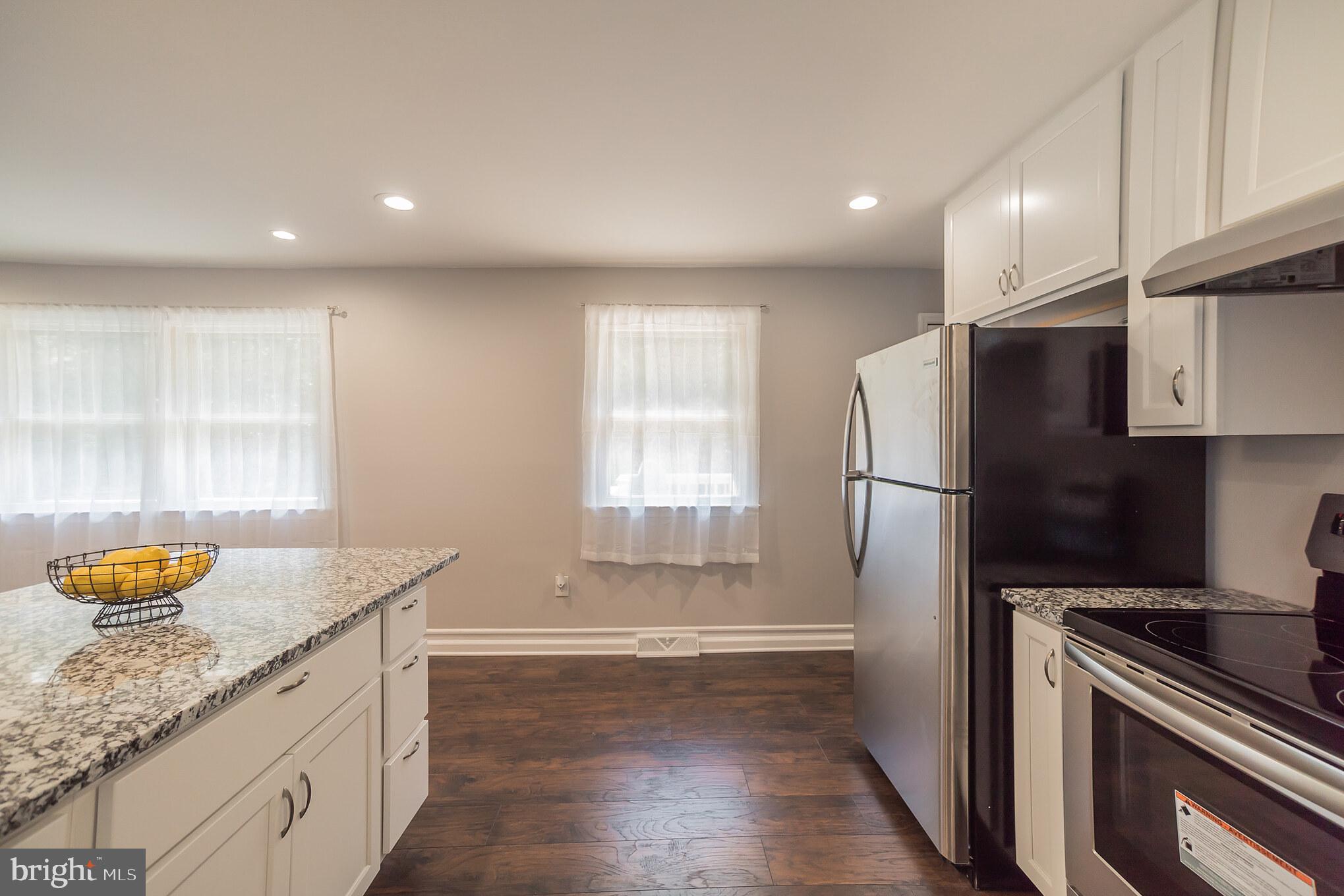 312 Fenwick Road Pilesgrove, NJ 08098 - Photo 22 of 40 a kitchen with granite countertop stainless steel appliances a refrigerator a sink and a stove