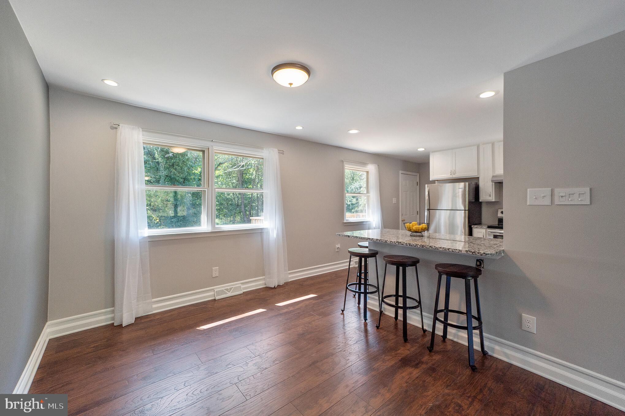 312 Fenwick Road Pilesgrove, NJ 08098 - Photo 5 of 40 a view of a dining room with furniture window and wooden floor