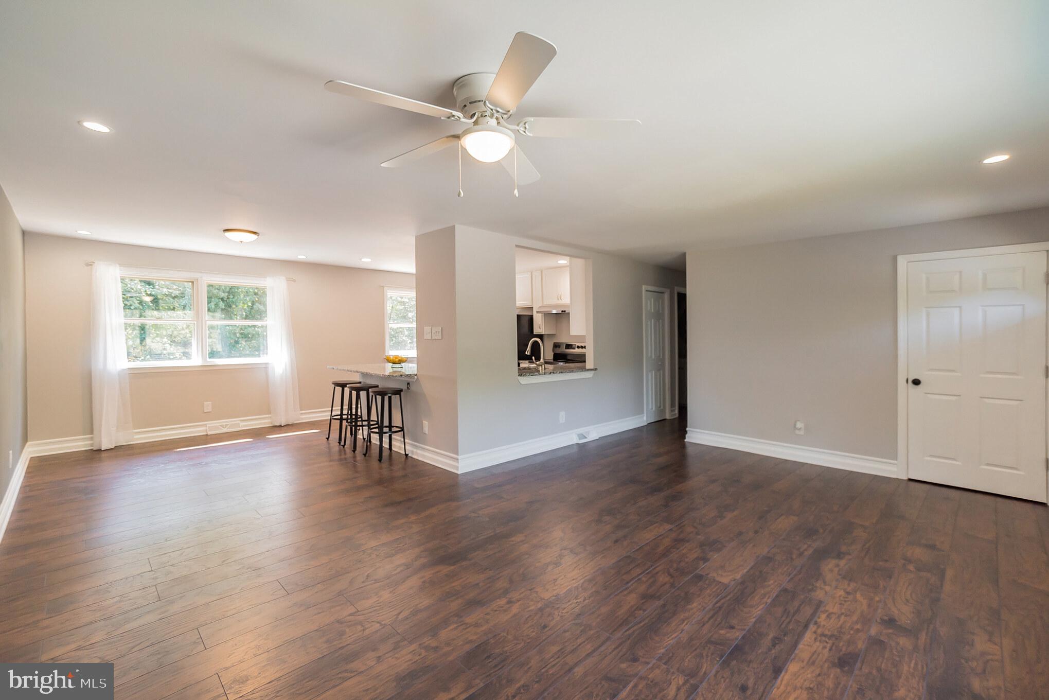 312 Fenwick Road Pilesgrove, NJ 08098 - Photo 6 of 40 a view of an empty room with wooden floor and a window