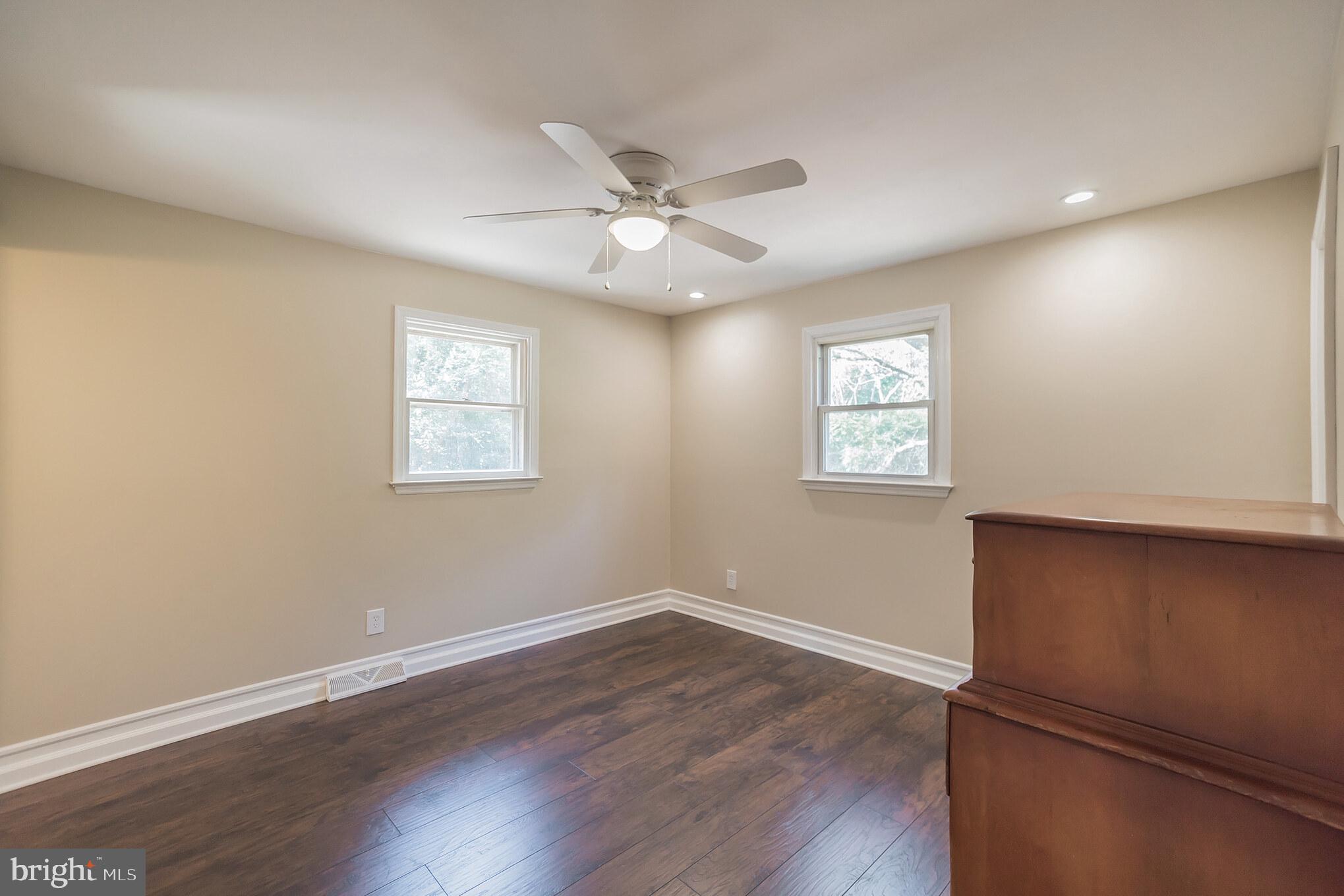 312 Fenwick Road Pilesgrove, NJ 08098 - Photo 8 of 40 a view of an empty room with wooden floor and a window