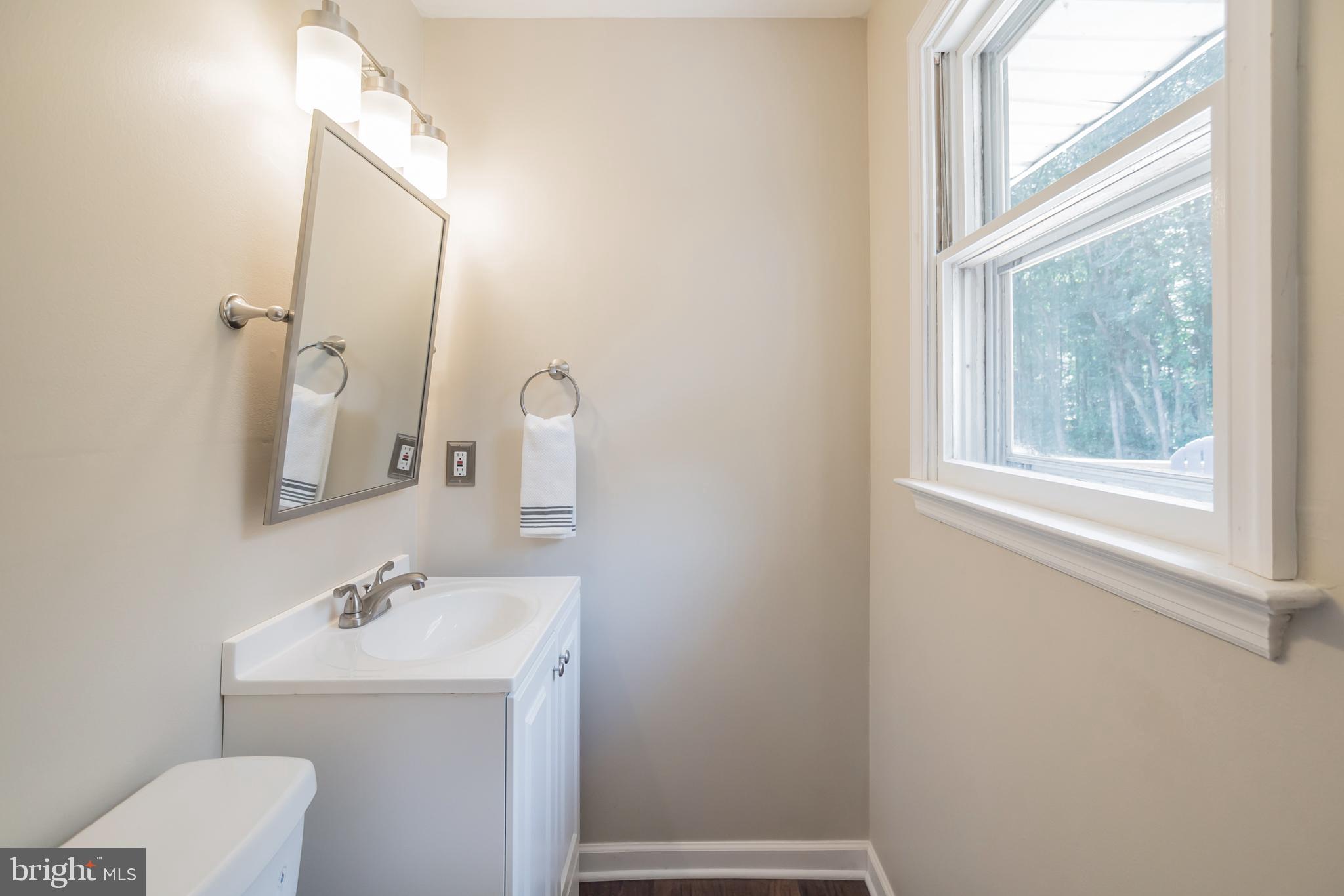 312 Fenwick Road Pilesgrove, NJ 08098 - Photo 10 of 40 a bathroom with a sink a toilet and a mirror
