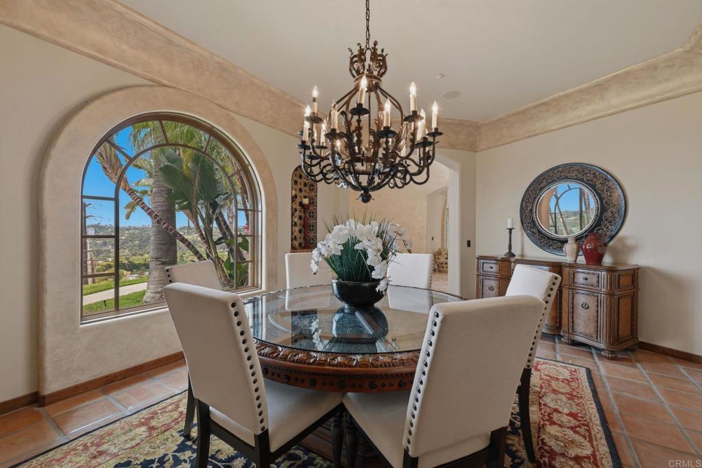 3244 Olivenhain Farms Road Encinitas, CA 92024 - Photo 12 of 47 a view of a dining room with furniture a chandelier and wooden floor
