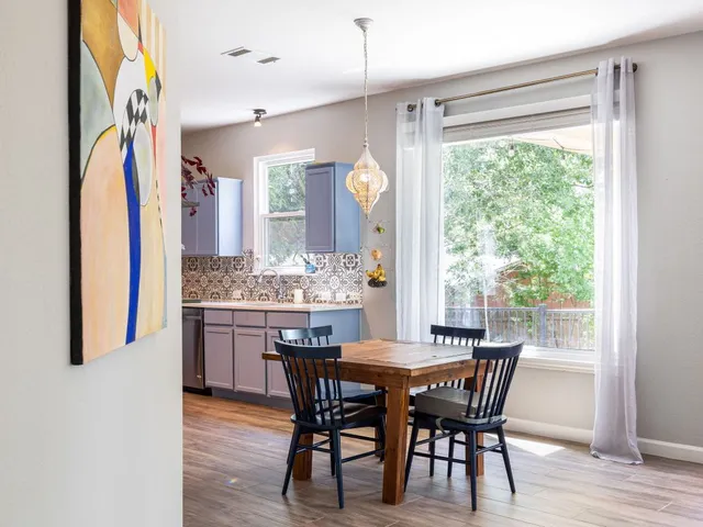 a view of a dining room with furniture and window