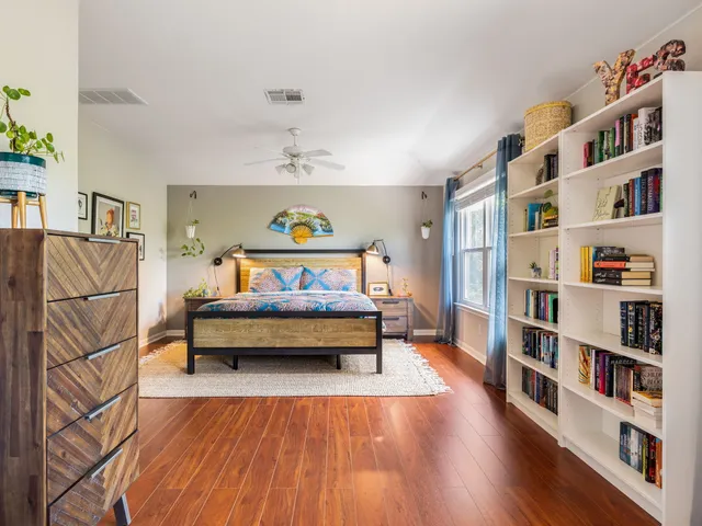 a bedroom with furniture and a book shelf