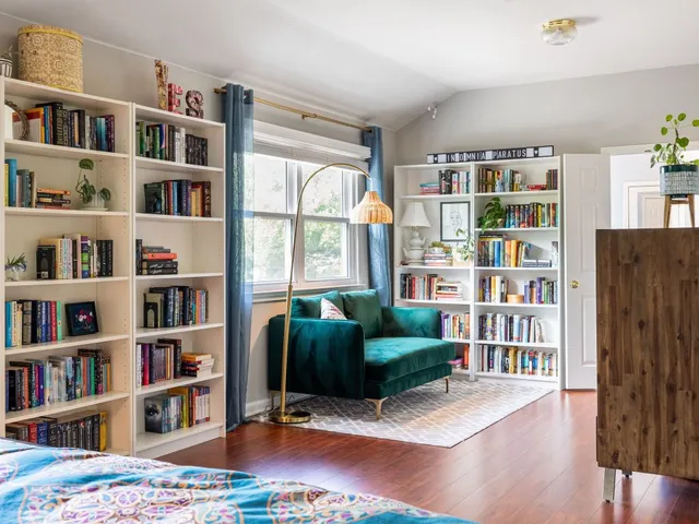 a living room with furniture and a book shelf