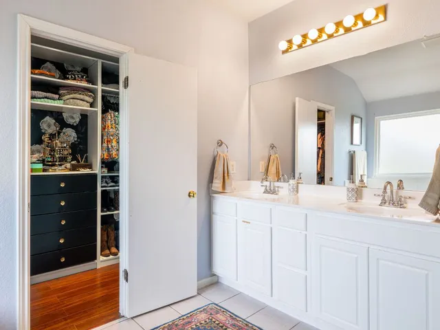 a bathroom with a double vanity sink and a mirror