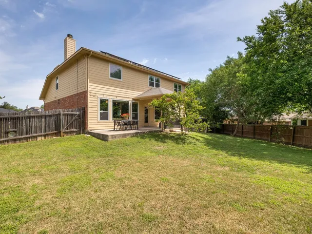 a view of a house with a yard and sitting area