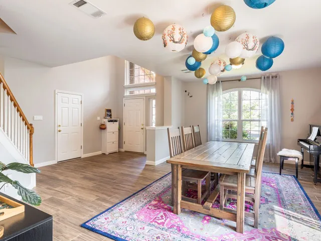 a view of a dining room and hall with wooden floor