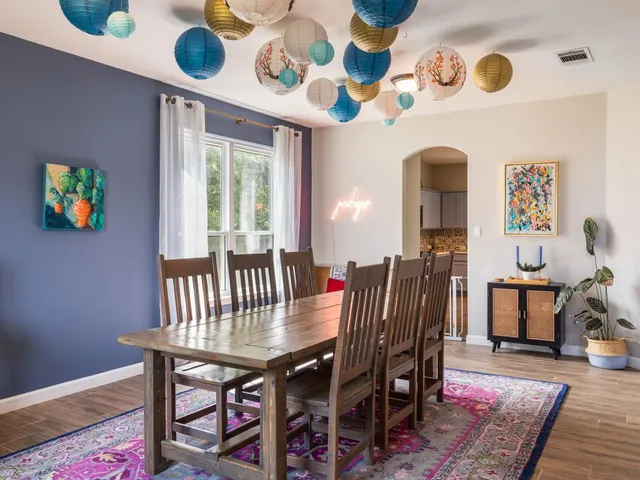 a view of a dining room with furniture and wooden floor