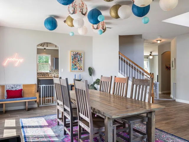 a dining room with furniture entryway and wooden floor
