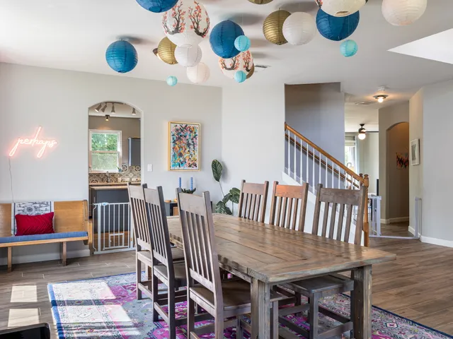 a dining room with furniture entryway and wooden floor