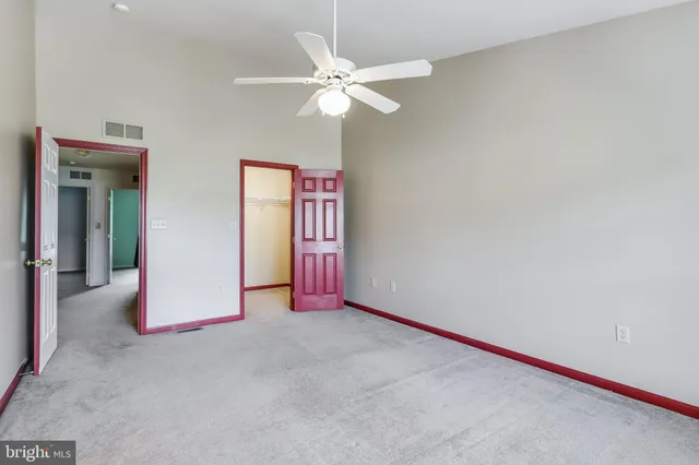 a view of an empty room with a ceiling fan