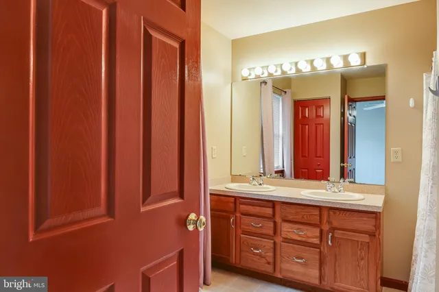a bathroom with a double vanity sink and a mirror