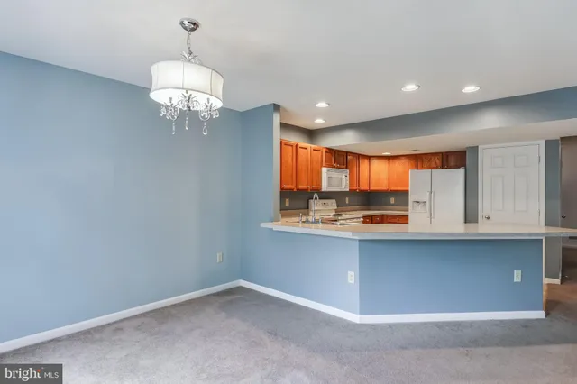 a view of kitchen with granite countertop stainless steel appliances and a sink