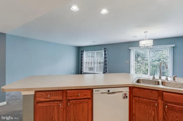a view of cabinets a sink and dishwasher in a kitchen