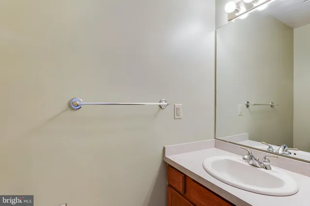 a bathroom with a sink vanity and a mirror
