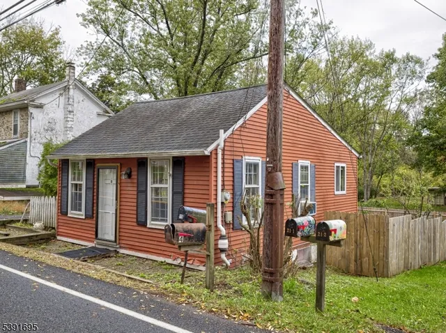 a view of a house with a yard and sitting area