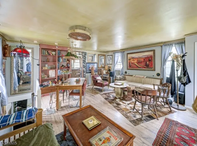 a living room with lots of furniture and painting on the wall