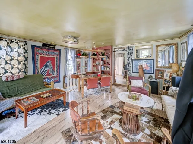 a living room with furniture a rug and a wall painting