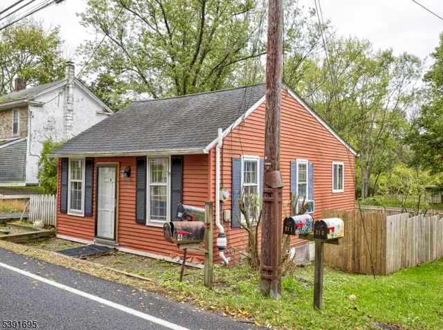a view of a house with a yard and sitting area