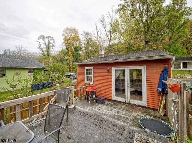 a view of a chair and tables in the balcony
